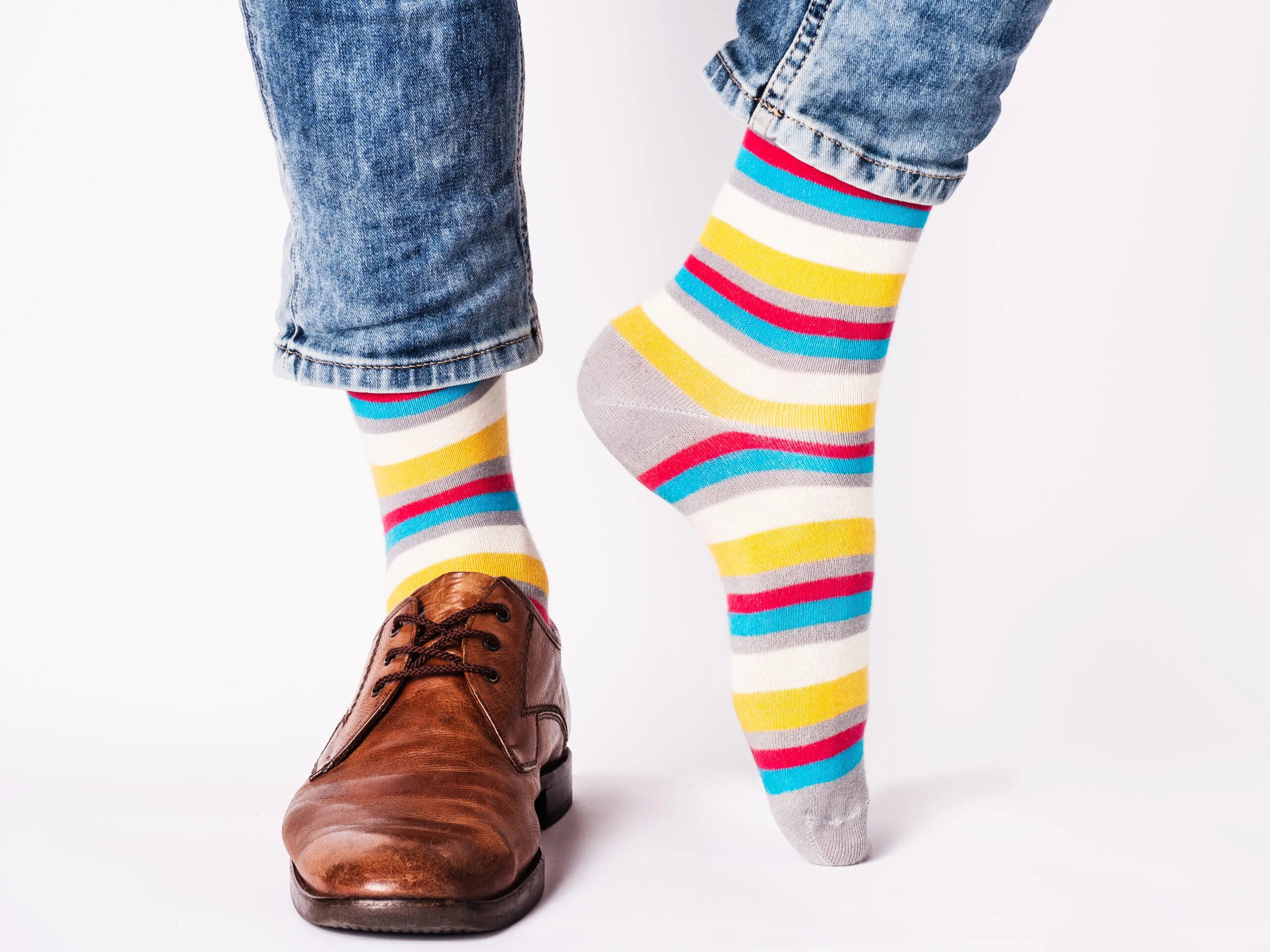 Men's legs, trendy shoes and bright socks. Close-up. Style, beauty and elegance concept